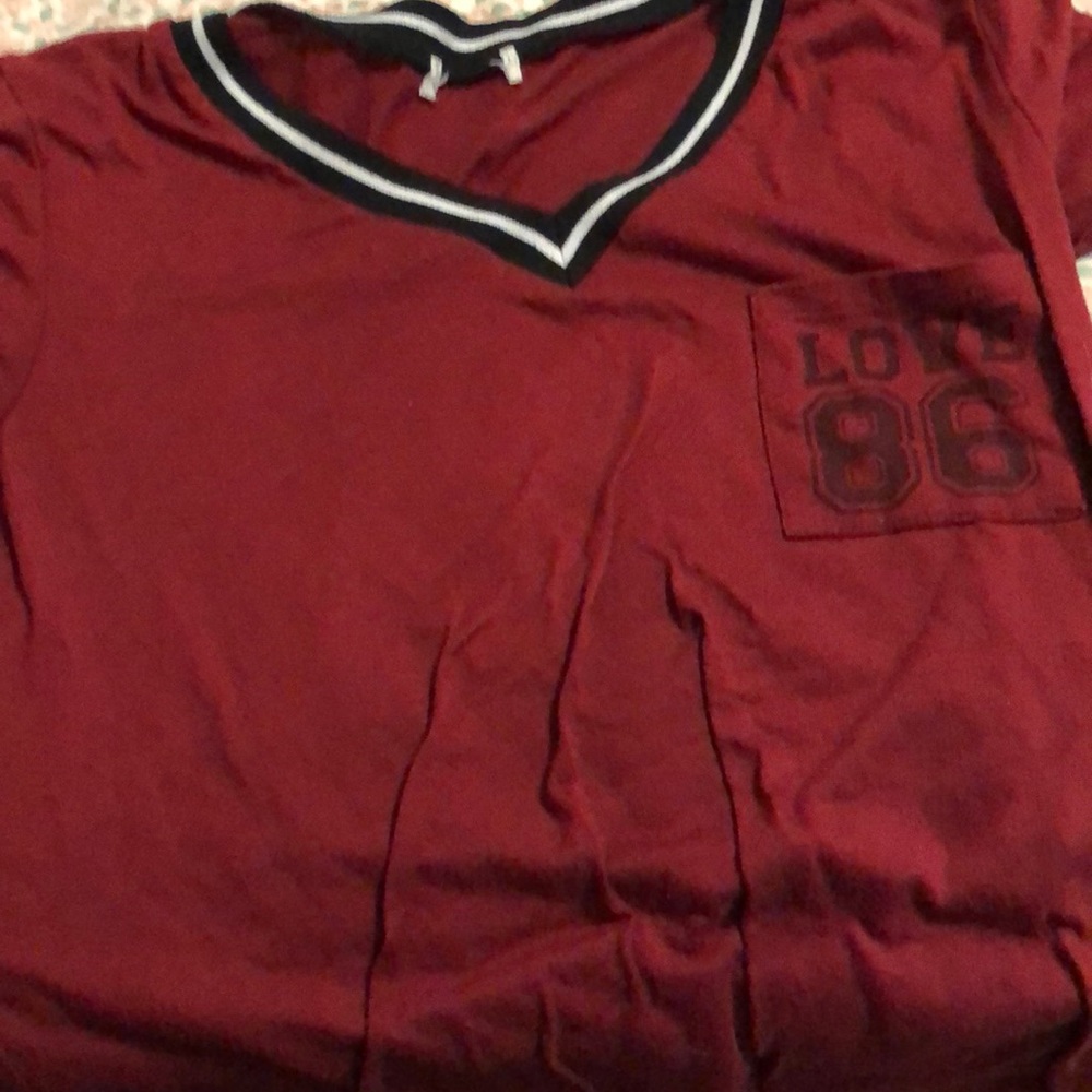A short-sleeved Victoria’s Secret maroon shirt